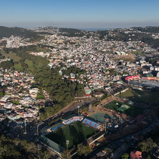 Shillong seen from above, dense rooftops filling a bowl in the hills